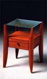 
      Comodino in tek , piano cristallo acidato.
      Teak-wood beside table, acidified crystal top.
      cm. 50x45 h 70 
      