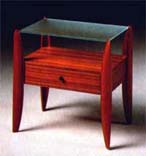 
      Comodino in tek , piano cristallo acidato.
      Teak-wood beside table acidified crystal top.
      cm. 70x45 h 70
      